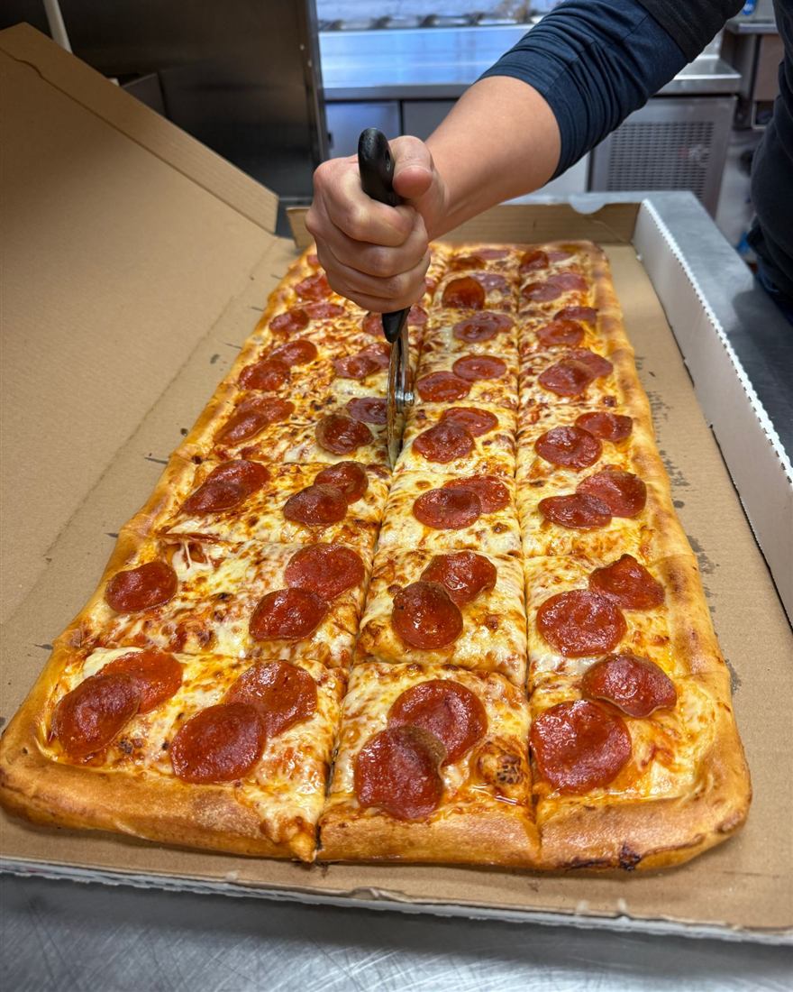Our real 32-slice Gigante pepperoni pizza, fresh from the oven and cut into 32 slices